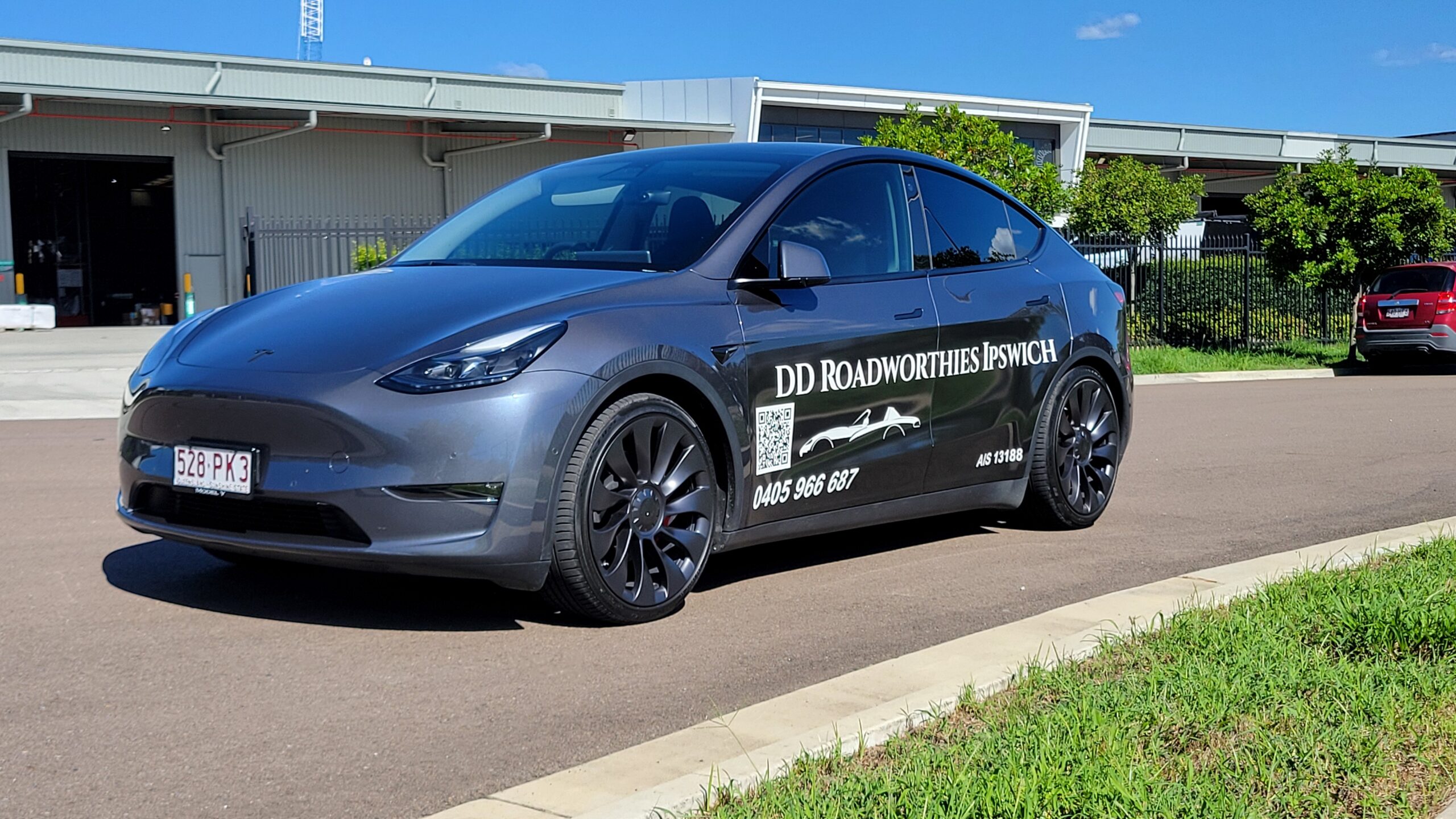 DD Road Worthies Ipswich Tesla for mobile roadworthy inspection services outside commercial units